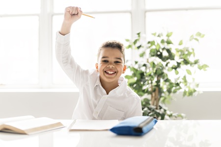 A cute Black boy doing homework at homeの写真素材