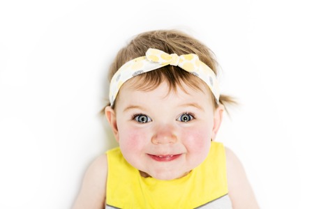 Portrait of a young girl in yellow on photo studioの写真素材