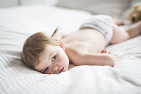 one years girl baby on the bedの写真素材