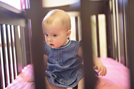 baby in the crib at home bedroomの写真素材