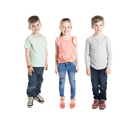 boy and girl posing over white studio backgroundの写真素材