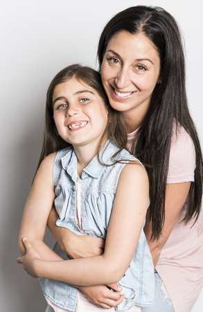 pretty mother standing with her cute daughterの写真素材