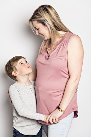 Mother and son on studio white backgroundの写真素材