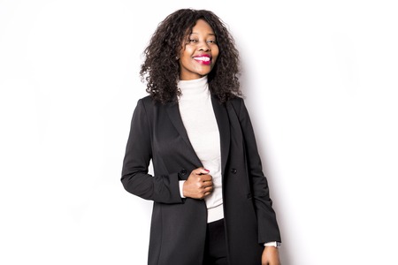 A black business woman poses for a portrait on studio whiteの写真素材