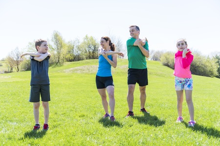 Parents with children sport running together outsideの写真素材