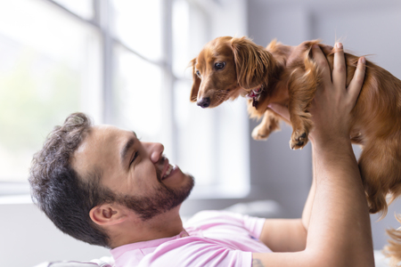 Young attractive mexican man at home sitting on couchの写真素材