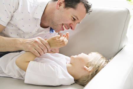 A Father and his five years kid on the sofa at homeの写真素材