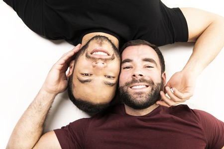 Young homosexuals gay couple love each other on a white background.の写真素材