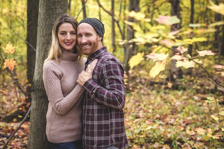 Young couple in love in a park on a autumn dayの写真素材