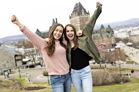 Quebec City scape with Chateau Frontenac and young friend teens enjoying the view.の写真素材