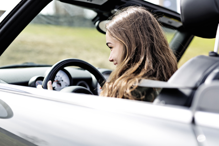 A young brunette woman in new carの写真素材