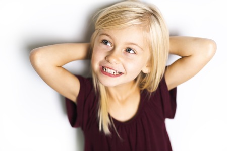 A Cute girl 5 year old posing in studio