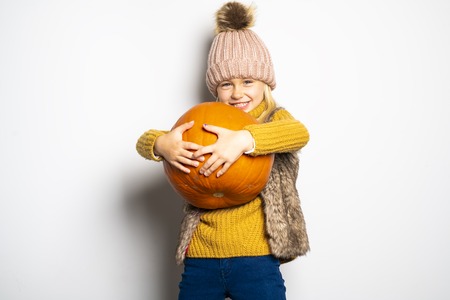 A Cute girl 5 year old posing in studio on autumn season studioの写真素材
