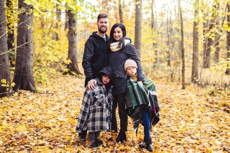 A Happy family resting in beautiful autumn park