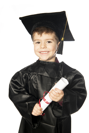 A Young boy 4 years old in graduation dress for the nursery classの写真素材