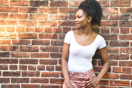 Colombian fashion woman outside close to a brick wall