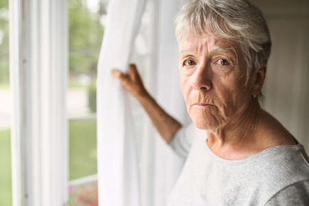 A worried senior woman at home felling very badの写真素材