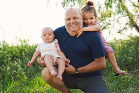 grandfather spending time with little baby girl and littledaughter during the day
