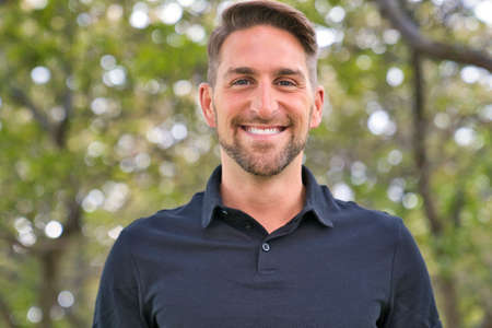 Portrait of a trendy young man on a sunny day in the cityの写真素材