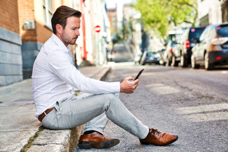 Portrait of an handsome man on the urban backgroundの写真素材