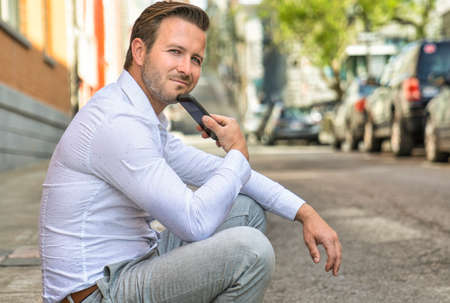 Portrait of an handsome man on the urban backgroundの写真素材