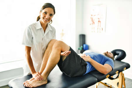 physiotherapist doing treatment with patient in bright office