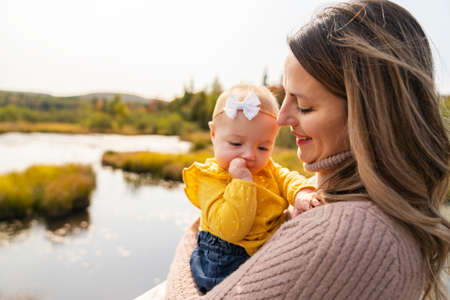 mother with baby on the fall seasonの写真素材