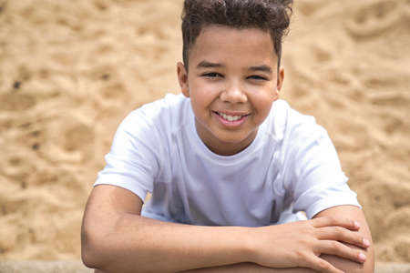 Teen afro american boy in the garden on the day time