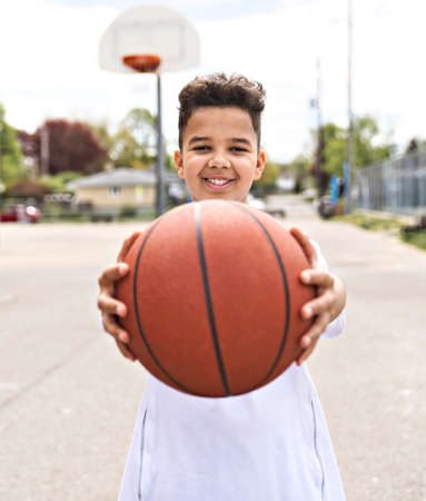 cute Afro american players playing basketball outdoorsの写真素材