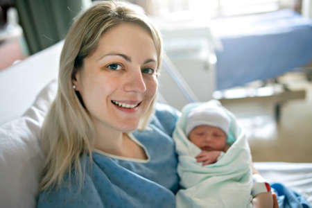 Mother with her newborn baby at the hospital a day after a natural birth laborの写真素材