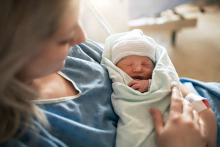 Mother with her newborn baby at the hospital a day after a natural birth laborの写真素材