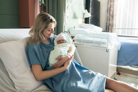 Mother with her newborn baby at the hospital a day after a natural birth labor