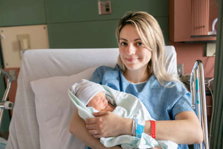 Mother with her newborn baby at the hospital a day after a natural birth labor