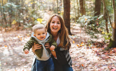 son and her mother in the autumn season in parkの写真素材