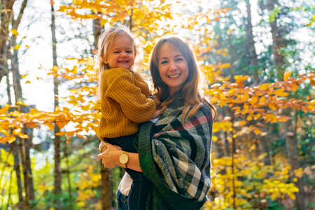 daughter and her mother in the autumn season in park