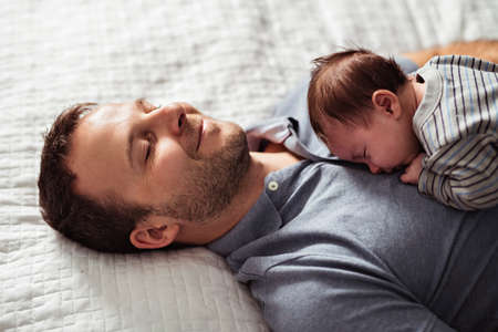 Father and Baby having wonderful time on bed on the morningの写真素材