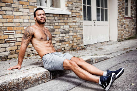 A sexy man outside in a city streetの写真素材