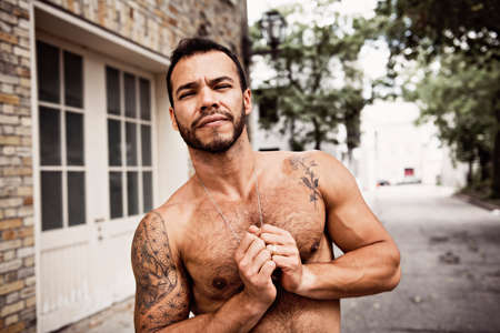 A sexy man outside in a city streetの写真素材