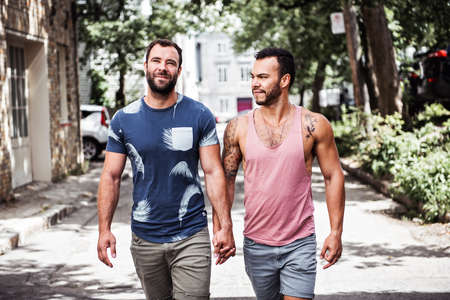 A Portrait of a happy gay couple outdoors in urban backgroundの写真素材