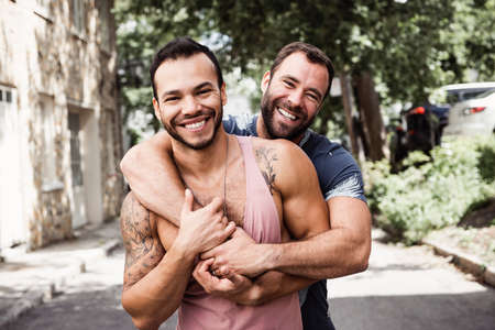 A Portrait of a happy gay couple outdoors in urban backgroundの写真素材
