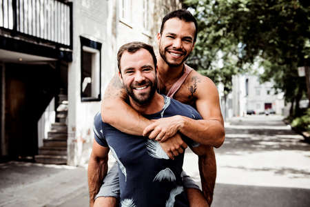 A Portrait of a happy gay couple outdoors in urban backgroundの写真素材