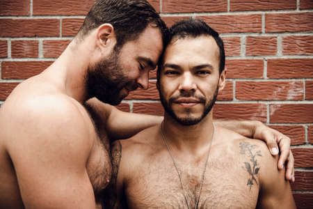 A Portrait of a happy gay couple outdoors in urban background