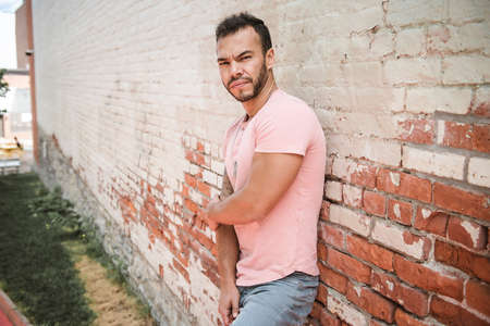 A sexy man outside in a city background