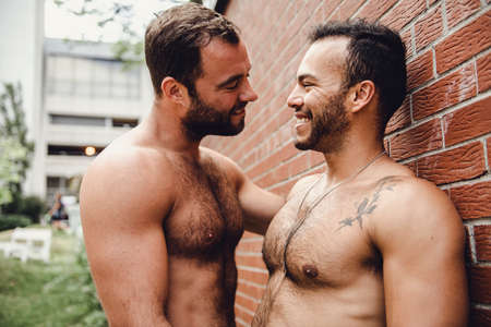 A Portrait of a happy gay couple outdoors in urban background
