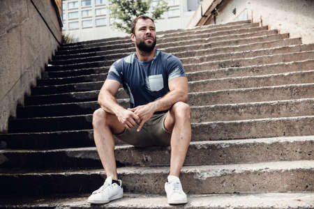 A sexy man outside in a city background