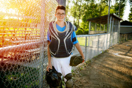 A children baseball catcher players standing on the playgroundの写真素材