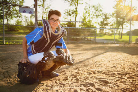 A children baseball catcher players standing on the playground