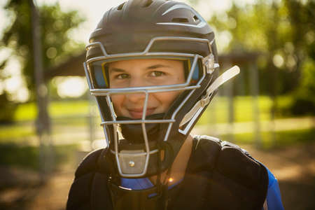 A children baseball catcher players standing on the playgroundの写真素材