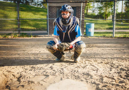A children baseball catcher players standing on the playground