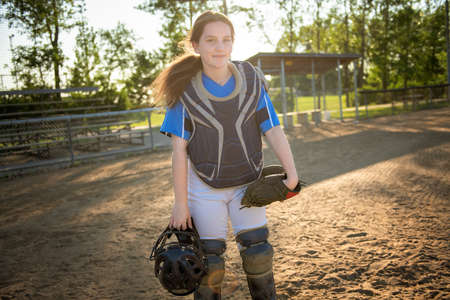 A children baseball catcher players standing on the playground